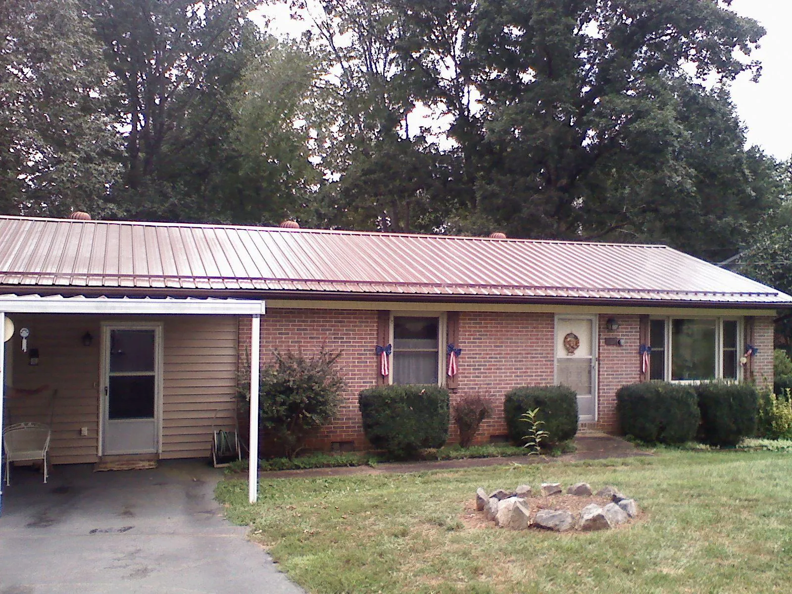 Bronze metal roof and carport on a brick ranch home — Roof Repair work by our crew in Neshanic Station